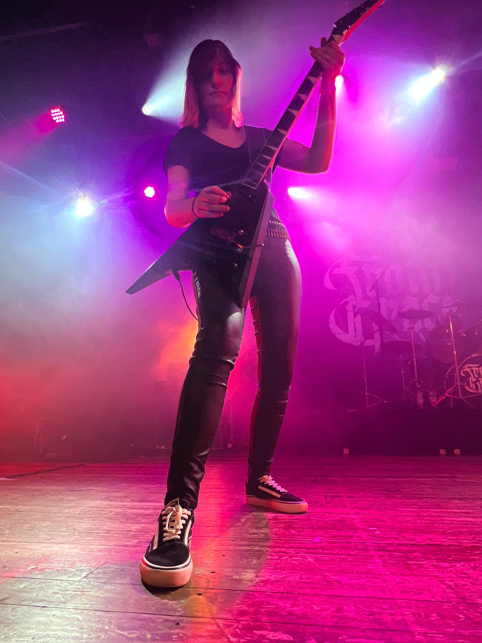 Jessi rhythm guitarist crushing riffs on stage